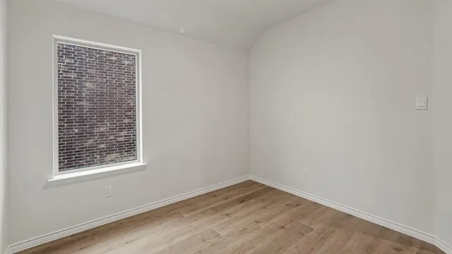 a view of kitchen with microwave and refrigerator