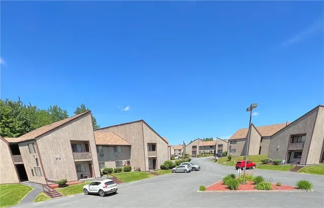 a car parked in front of white house