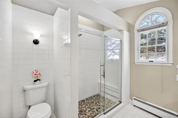 a bathroom with a toilet a sink and a shower