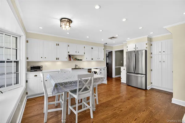 a kitchen with stainless steel appliances kitchen island granite countertop a refrigerator and a stove top oven