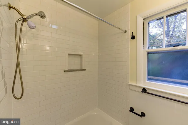 a bathroom with a glass shower door