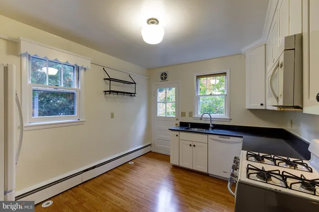 a kitchen with stainless steel appliances a sink stove and cabinets