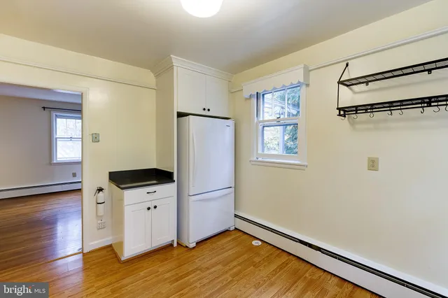 a view of a refrigerator in kitchen and wooden floor