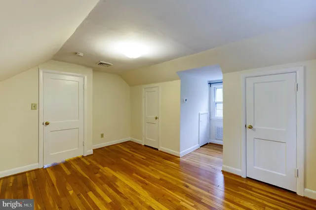 a view of a room that has a wooden bed