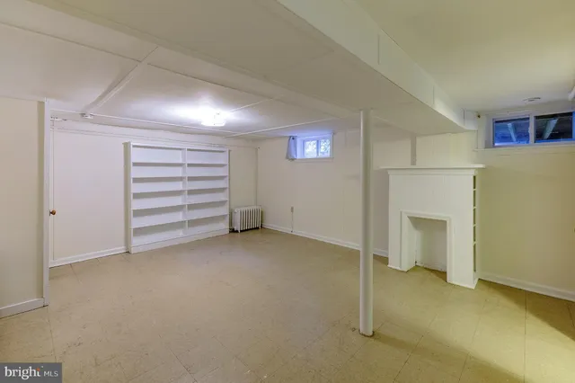 a view of an empty room with a fireplace