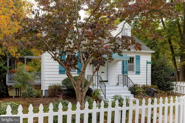a front view of house with a garden