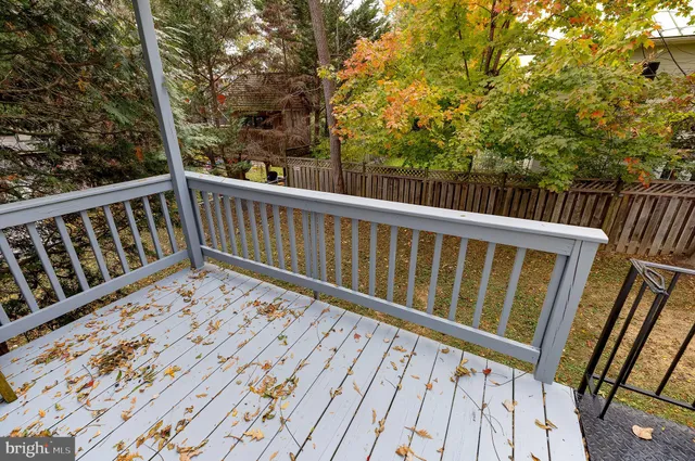 a view of balcony with wooden floor and fence