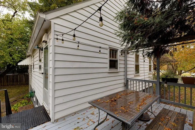 a view of a house with backyard and wooden fence