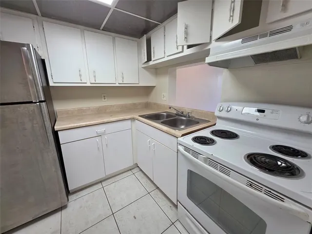 a kitchen with cabinets and appliances