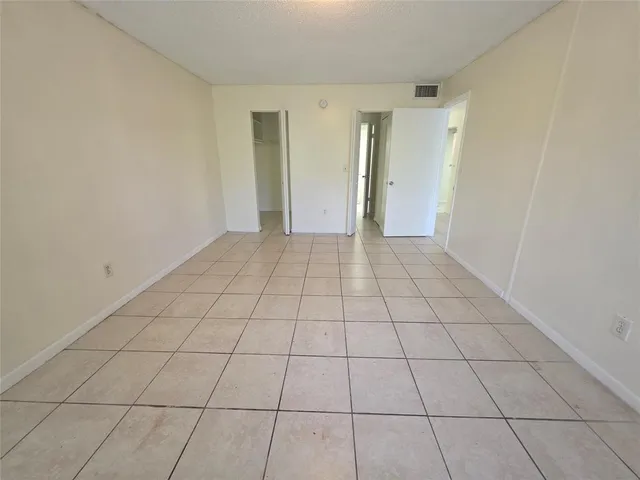 a view of walk in closet with clothes