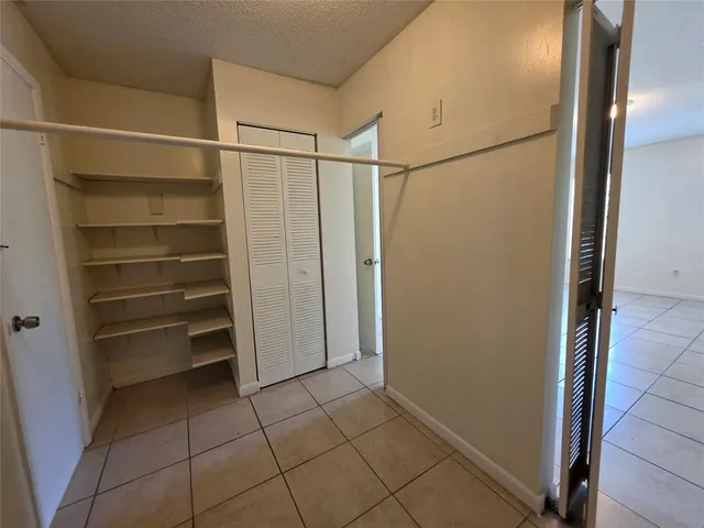 a bathroom with a granite countertop toilet and a shower