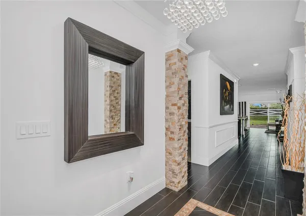 view of hallway with wooden floor and stairs