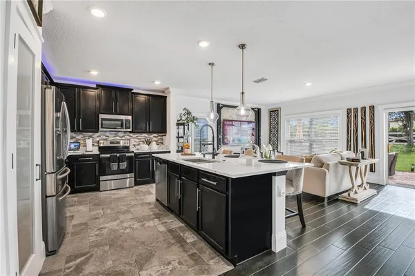 a kitchen with a sink refrigerator and cabinets