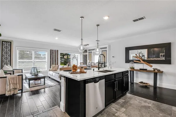 a kitchen with stainless steel appliances granite countertop a sink and a stove