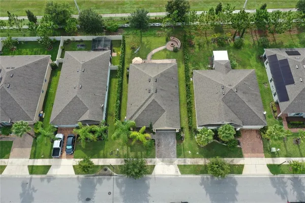 an aerial view of a house with outdoor space and lake view