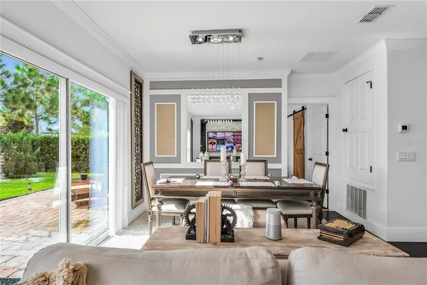 a living room with furniture a large window and a table