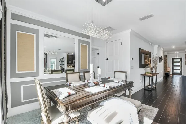 a living room with dining table and wooden floor