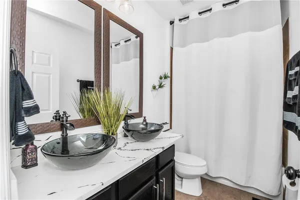 a bathroom with a sink a toilet and mirror