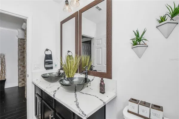 a bathroom with a sink a mirror and vanity
