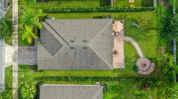 a aerial view of a house with garden space and outdoor seating