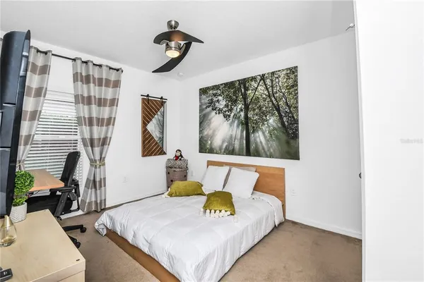 a bedroom with furniture and a window