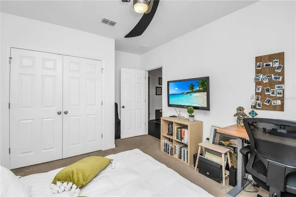 a bedroom with furniture and a flat screen tv