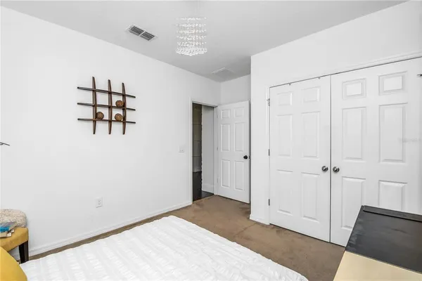 a bathroom with a double vanity sink a two mirror a window and a bathtub