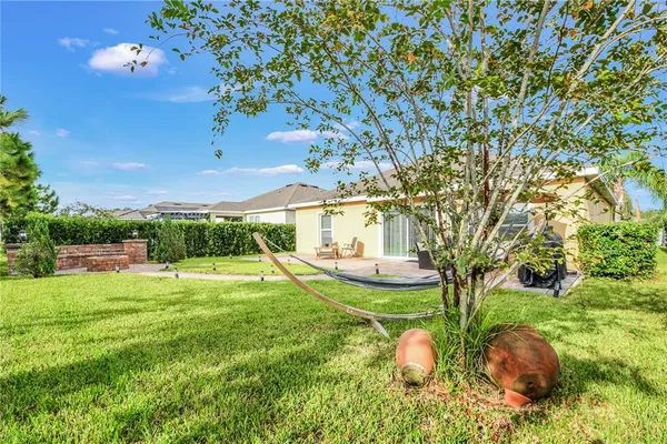 a view of a house with backyard sitting area and garden