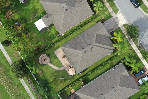 an aerial view of a house with a yard
