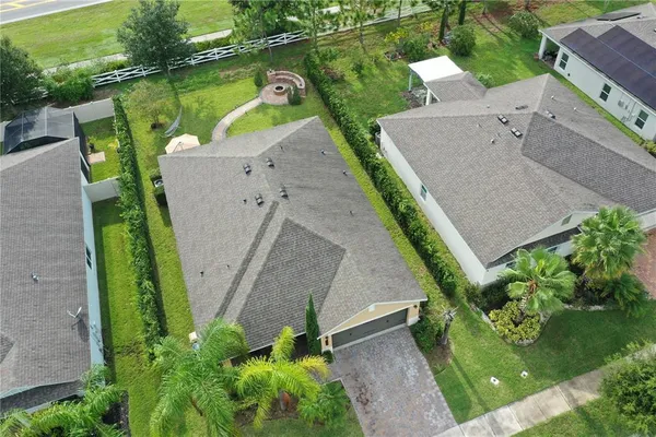 an aerial view of a house with a yard and lake view