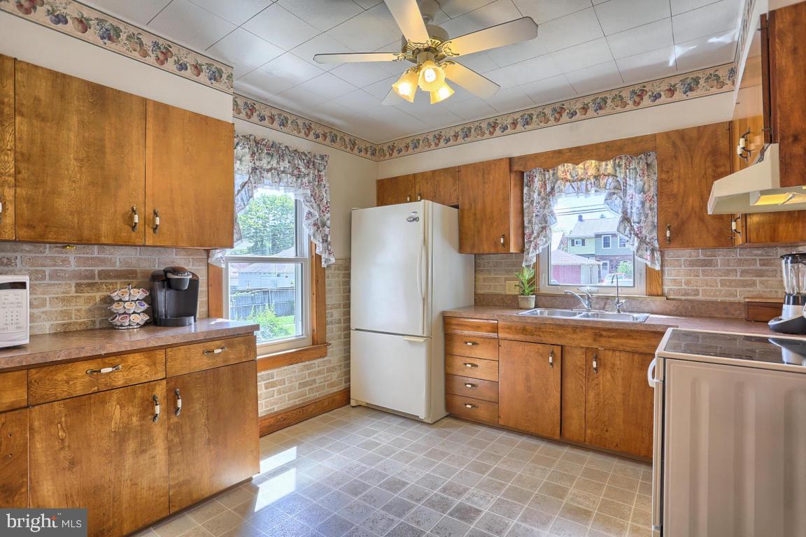 306 East New Street Lititz, PA 17543 - Photo 20 of 31 a kitchen with stainless steel appliances granite countertop a refrigerator a sink dishwasher a stove with white cabinets and wooden floor