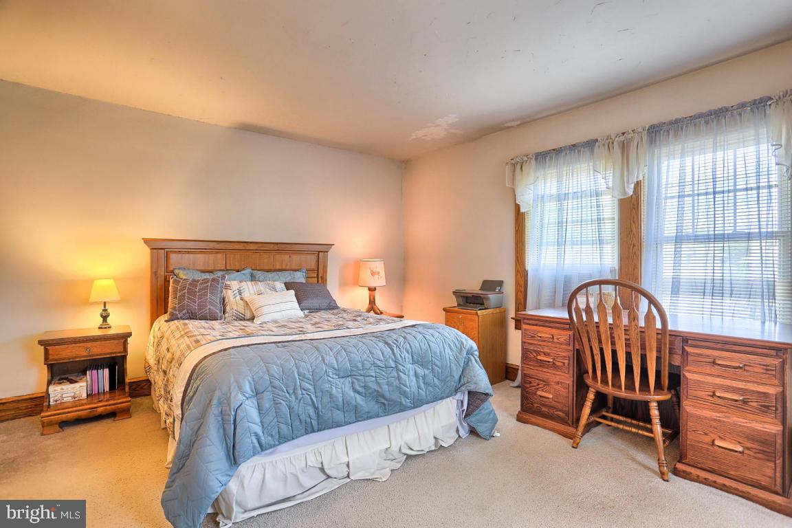 306 East New Street Lititz, PA 17543 - Photo 29 of 31 a bedroom with a bed a lamp and a large window