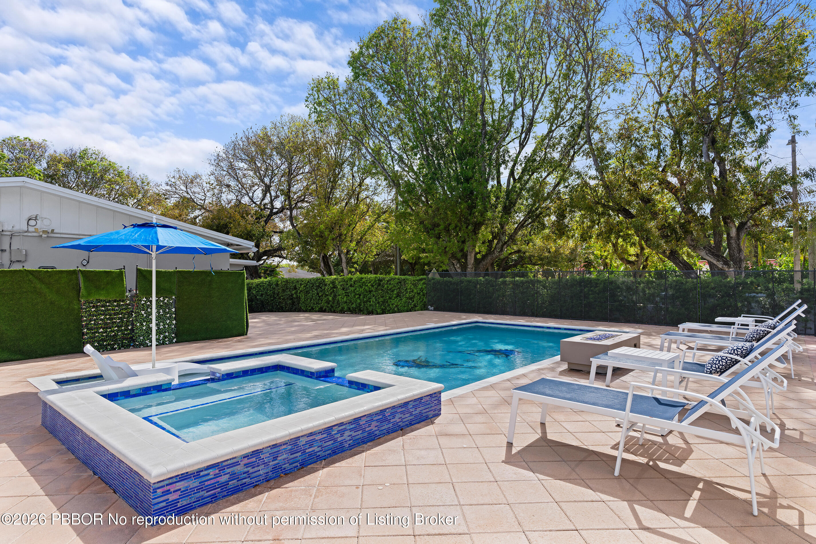 747 Avon Road West Palm Beach, FL 33401 - Photo 19 of 29 a view of a patio with a dining table and chairs under an umbrella