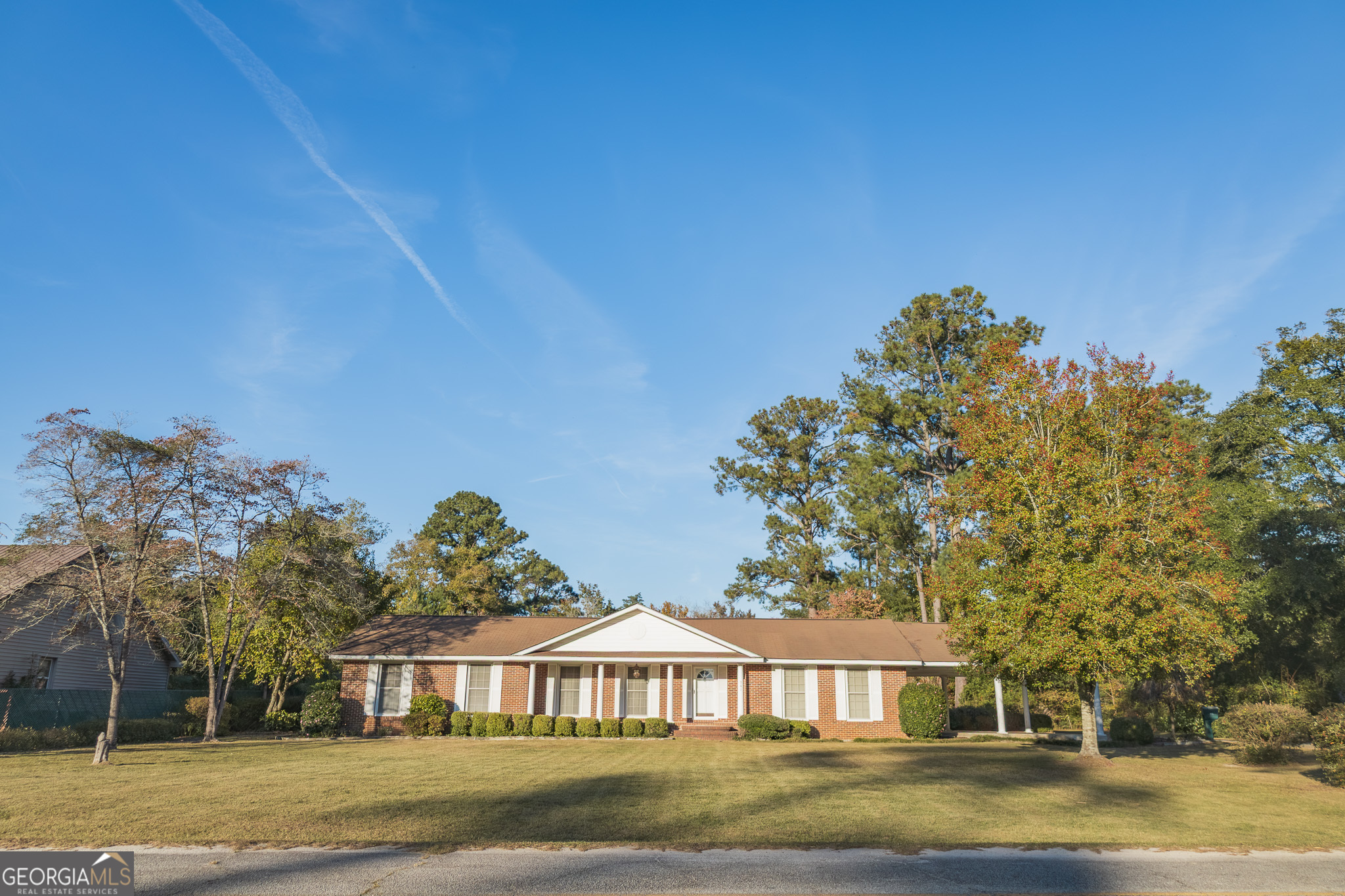 a front view of a house with a garden