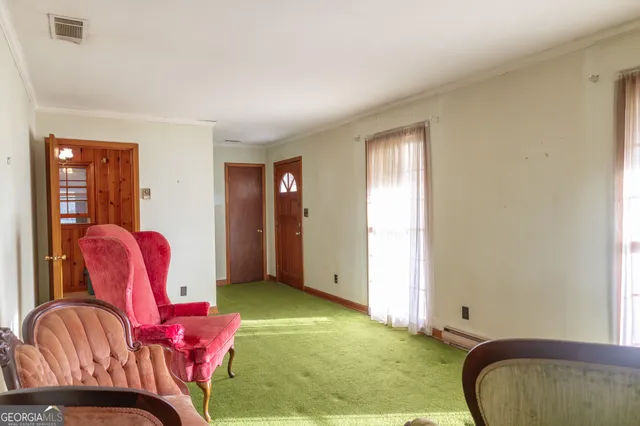 a view of a big house with a big yard and large trees