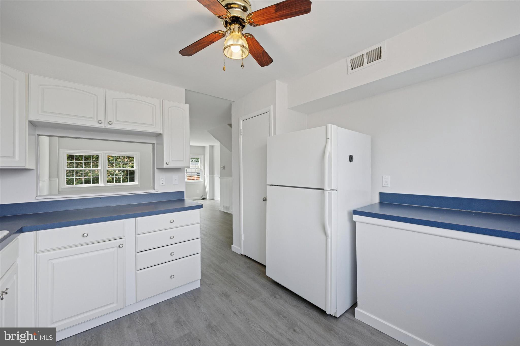 12136 Sweet Briar Road Philadelphia, PA 19154 - Photo 13 of 33 a kitchen with white cabinets and white appliances