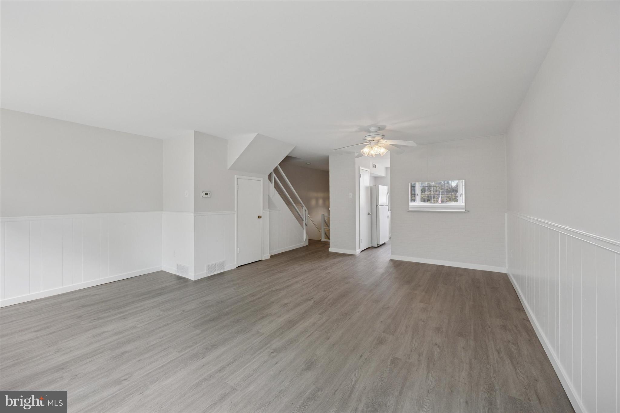 12136 Sweet Briar Road Philadelphia, PA 19154 - Photo 7 of 33 an empty room with wooden floor and windows