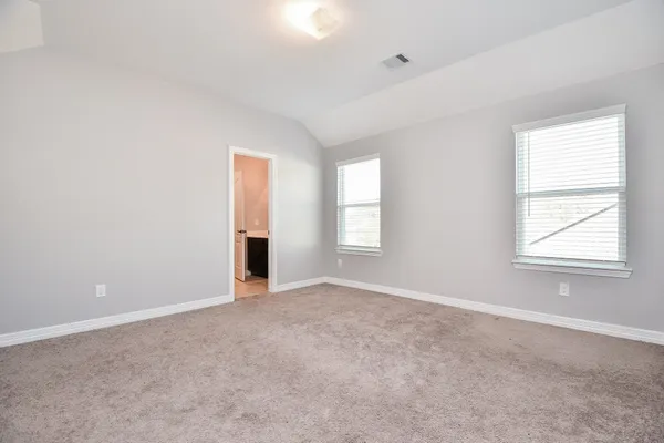 an empty room with windows and closet