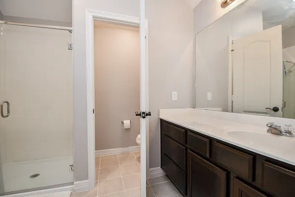 a bathroom with a granite countertop sink and mirror