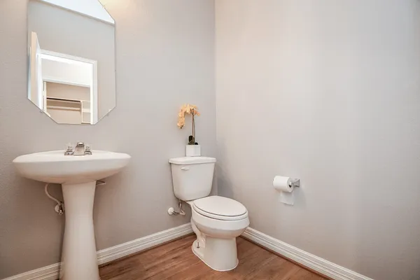 a bathroom with a sink toilet and a mirror