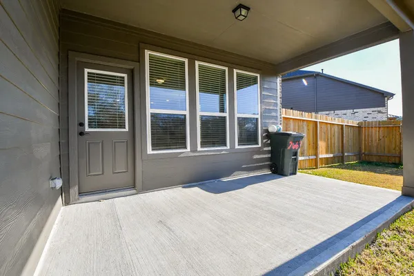 a view of a house with a backyard porch and sitting area