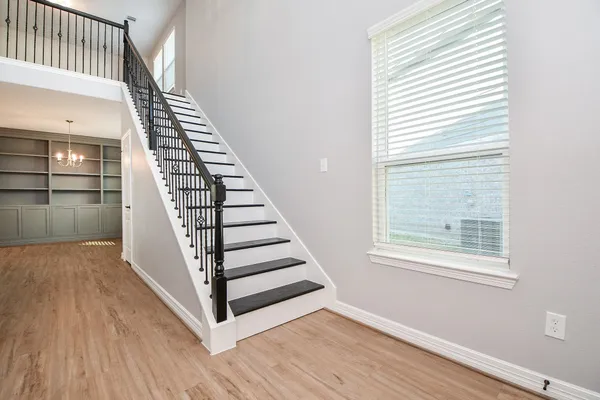 a view of entryway and hall with wooden floor