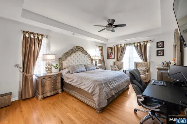 a bedroom with a bed wooden floor and window