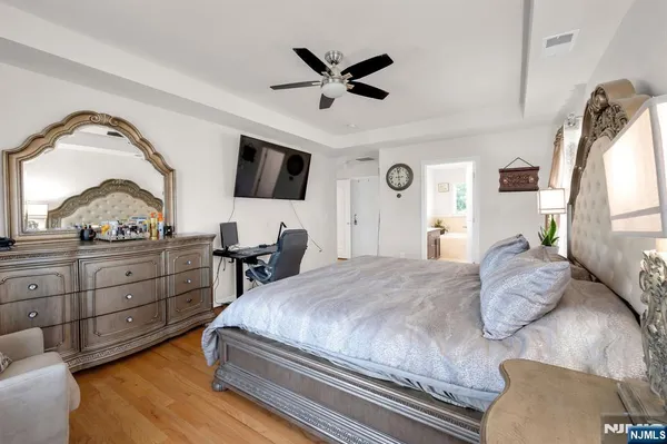 a bedroom with a large bed and a flat screen tv
