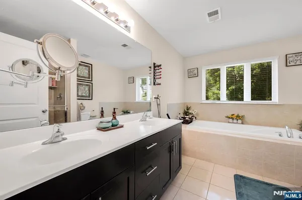 a bathroom with a double vanity sink mirror and double