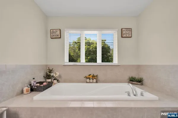 a bathroom with a bathtub and a window