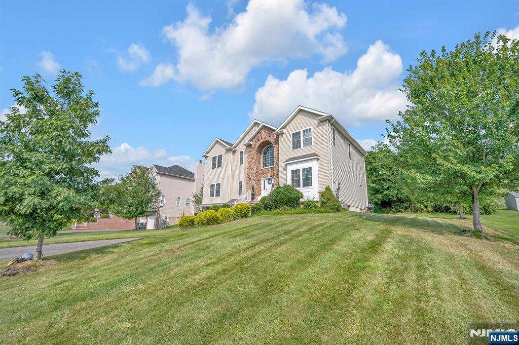 6 Jacob Way Phillipsburg, NJ 08865 - Photo 3 of 38 a view of a white house with a big yard and large trees
