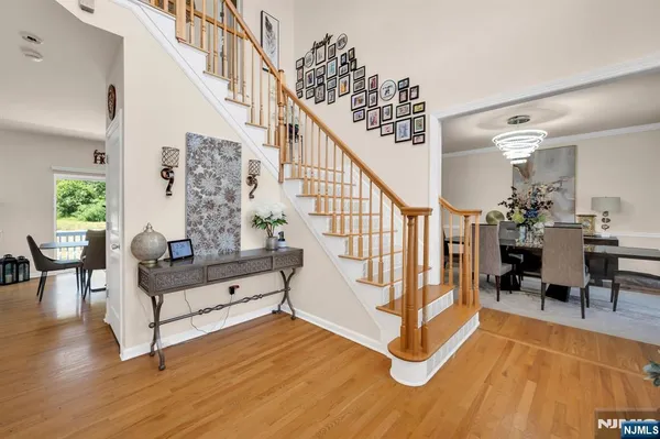 a view of entryway dining room and hall with wooden floor