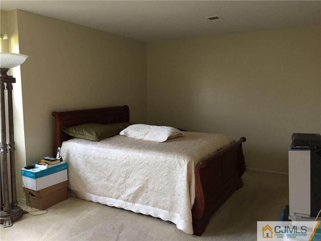 1623 Raspberry Court, Unit 1623 Edison, NJ 08817 - Photo 14 of 18 a bedroom with a bed and a window
