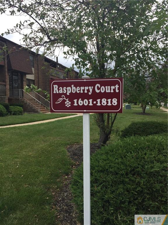 1623 Raspberry Court, Unit 1623 Edison, NJ 08817 - Photo 17 of 18 a sign that is sitting on a brick wall